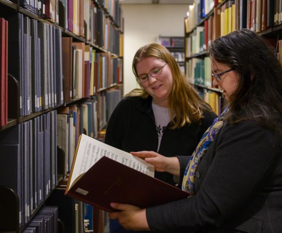 Music History student and professor in the library archives